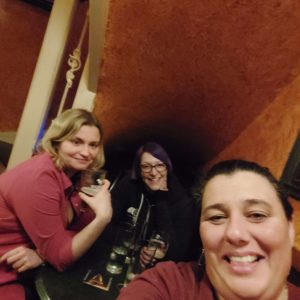 Three ladies under the stairs in the pub, with your author in the middle. Does this count as a snug? Sure.