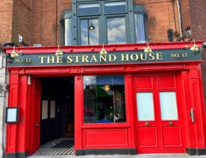 Outside The Strand House: red frontage