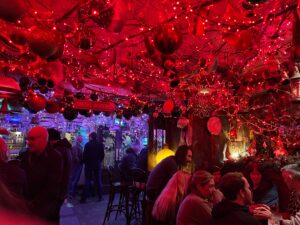 Inside the Ginger Man: a red glow from the decorations