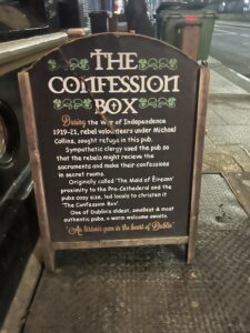 A terrible picture of the sandwich board outside The Confession Box