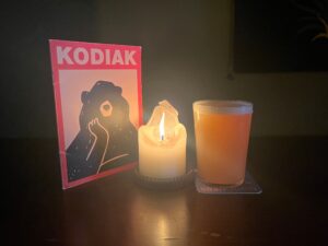 A menu, candle and beer at Kodiak